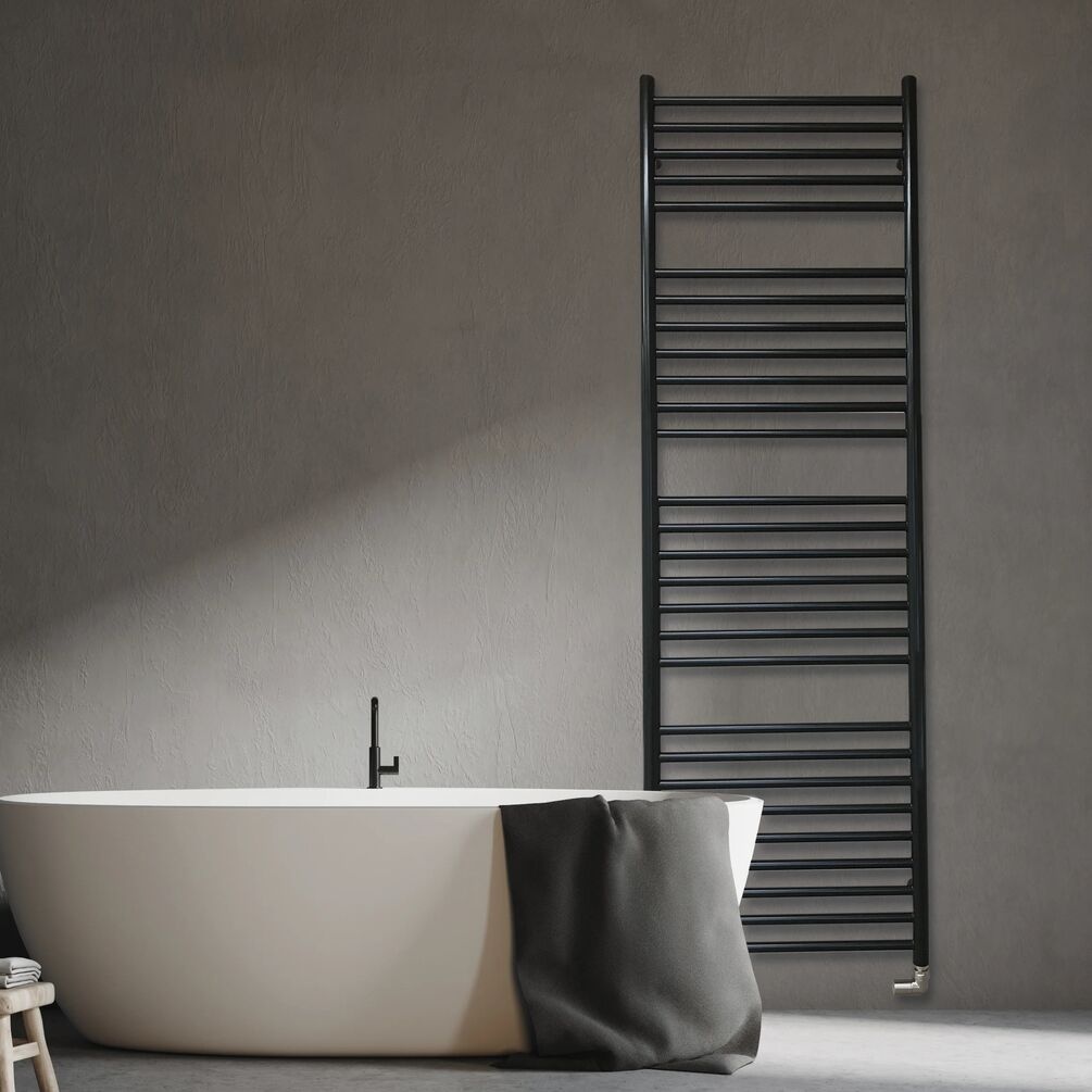 Lifestyle image of the The Sussex Range by JIS Beacon 1650mm x 520mm Black Heated Towel Rail installed on a wall behind a freestanding bathtub